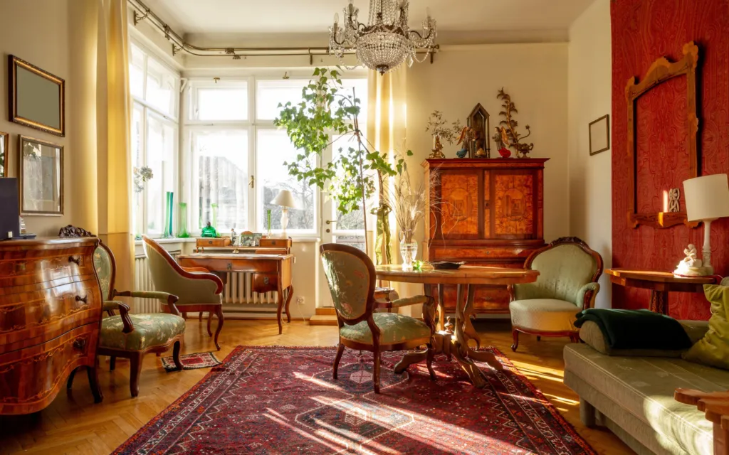 Salon ancien meublé de fauteuils, d’un cabinet marqueté et d’un tapis
